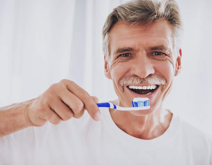 Man-brushing-teeth-caring-dental-work Dental crowns